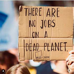 Demonstration poster: 'There are no jobs on a dead planet' 